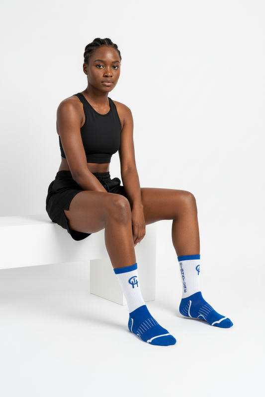 Black Woman wearing black athletic wear and royal blue socks with a chi logo on a white background