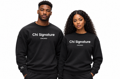 A man and a woman modeling matching black crewneck sweatshirts with 'Chi Signature CHICAGO' printed in white across the chest, set against a plain white background.