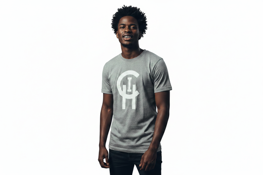 A man wearing a heather gray crewneck t-shirt with a large white stylized 'Chi logo on the front, standing against a solid white background.